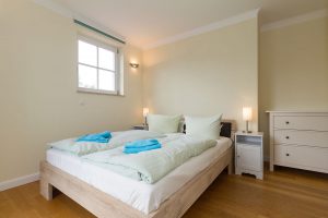 Bett im Schlafzimmer der Residenz Leuchtturm Whg. 17